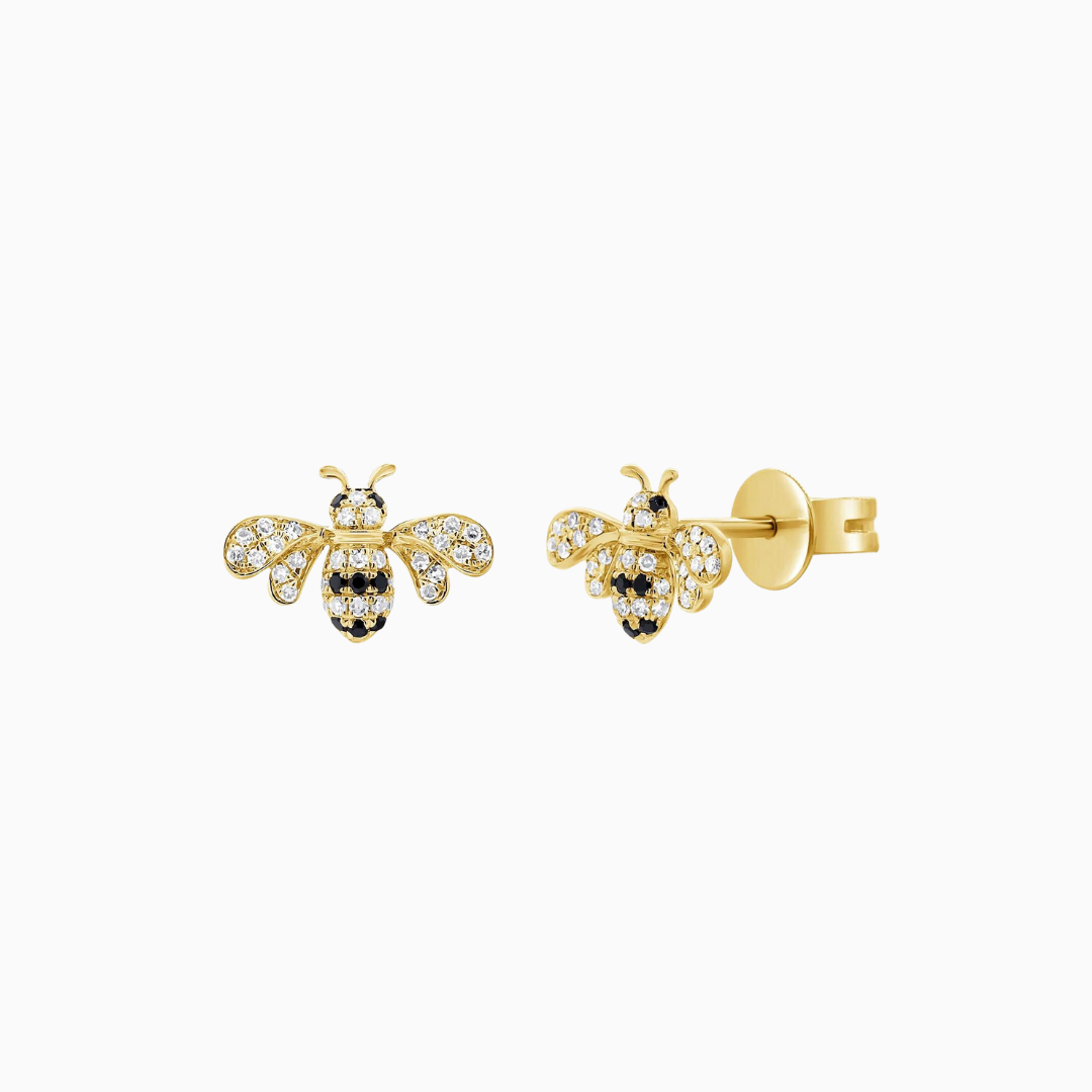 Crafted from 14k Gold, our Black and Natural Diamond Bumble Bee Stud Earrings come in a pair and are available in White, Yellow and Rose Gold.  White Diamond Weight: 0.12 ct. Black Diamond Weight: 0.05 ct.