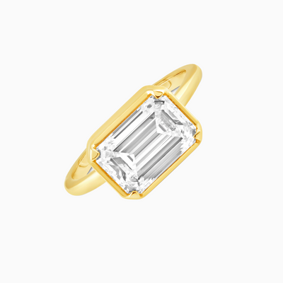  This GIA Certified 2.94 Carat D VS1 Emerald Cut Lab Grown Diamond is bezel-set in an 18k Yellow Gold band with four prongs.  2.94 CT Emerald Cut D VS1, Lab-Grown