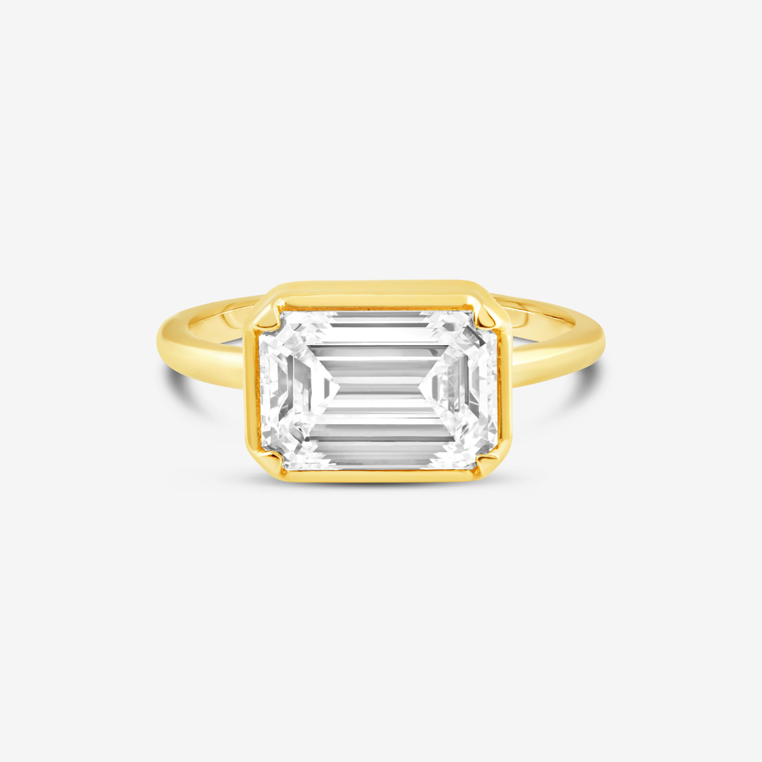  This GIA Certified 2.94 Carat D VS1 Emerald Cut Lab Grown Diamond is bezel-set in an 18k Yellow Gold band with four prongs.  2.94 CT Emerald Cut D VS1, Lab-Grown