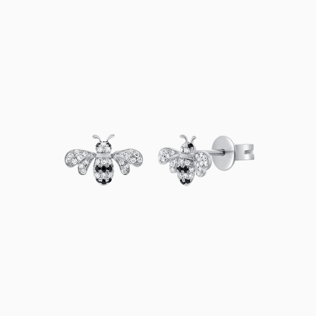 Crafted from 14k Gold, our Black and Natural Diamond Bumble Bee Stud Earrings come in a pair and are available in White, Yellow and Rose Gold.  White Diamond Weight: 0.12 ct. Black Diamond Weight: 0.05 ct.