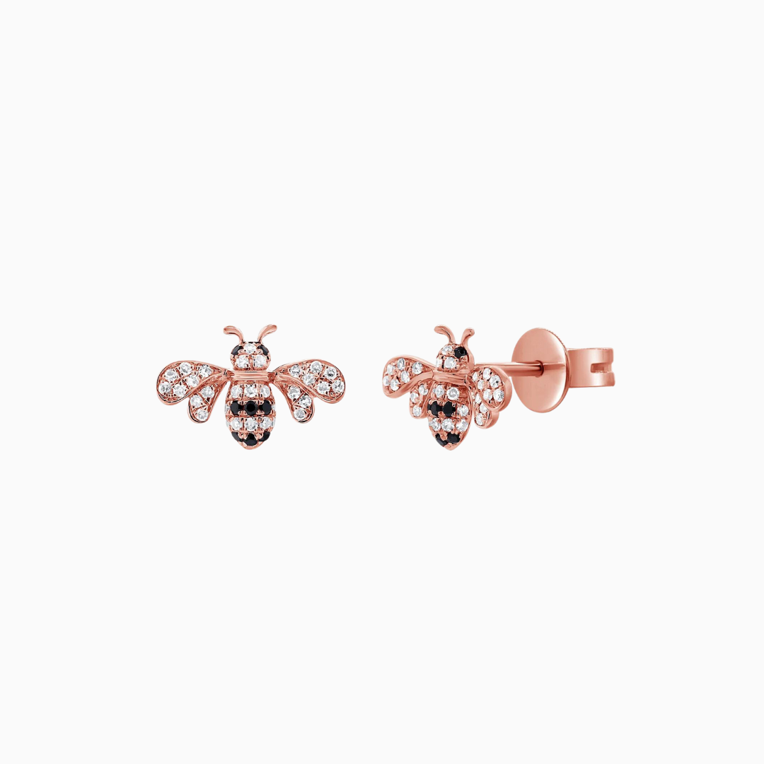 Crafted from 14k Gold, our Black and Natural Diamond Bumble Bee Stud Earrings come in a pair and are available in White, Yellow and Rose Gold.  White Diamond Weight: 0.12 ct. Black Diamond Weight: 0.05 ct.