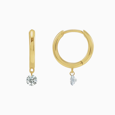 The perfect every day hoops with just the right amount of sparkle! These special earrings feature a dangling natural diamond that's drilled right into the diamond helping it appear as if it's floating.