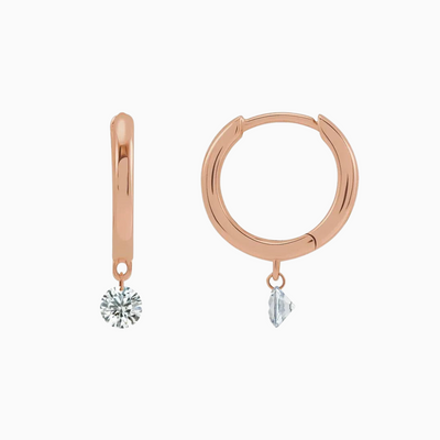 The perfect every day hoops with just the right amount of sparkle! These special earrings feature a dangling natural diamond that's drilled right into the diamond helping it appear as if it's floating.