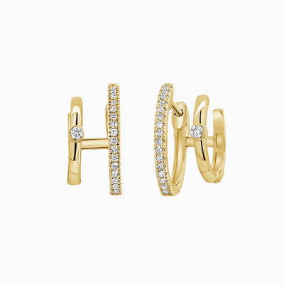 Gold hoop earrings with diamond accents on a white background