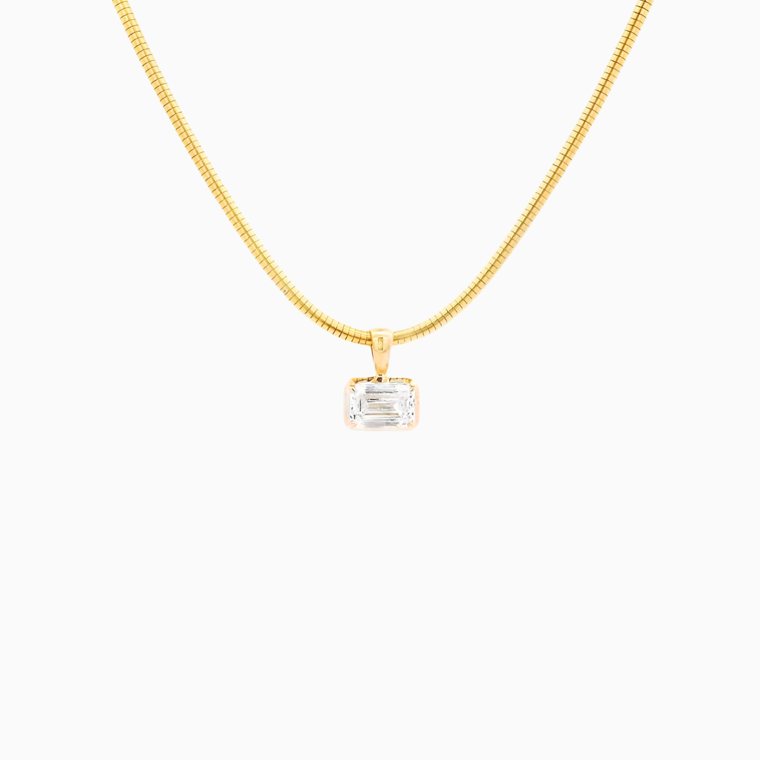 Gold necklace with a pendant on a white background