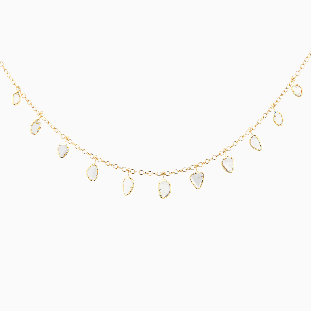 This Diamond Slice Chain Necklace consists of 14k gold with 11 diamonds cut in slices along the chain.  Each piece is unique as the diamonds have different shapes and inclusions. Stones are approx .3-.5 cm wide 11 rose cut diamonds 16.5-17.75" adjustable chain -from Celine D'Aoust