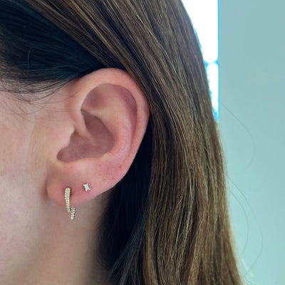 The Diamond Mini Hook Earring features curving rows of diamonds in the front and back of your lobes (for curious minds, the butterfly back post holds the second diamond hook). With .15 carats of diamond for the pair, this statement earring is sure to round out your look.