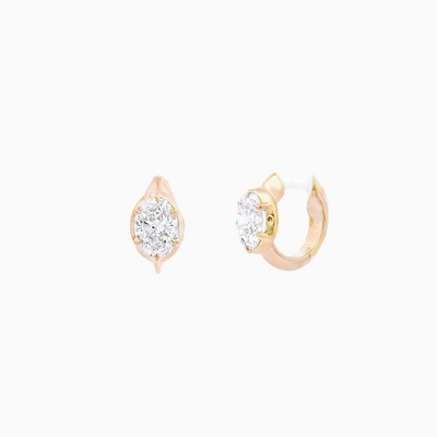 Pair of gold hoop earrings with clear gemstones on a white background