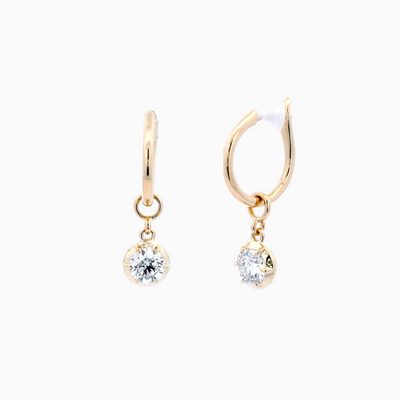 Gold hoop earrings with small round diamond on a white background