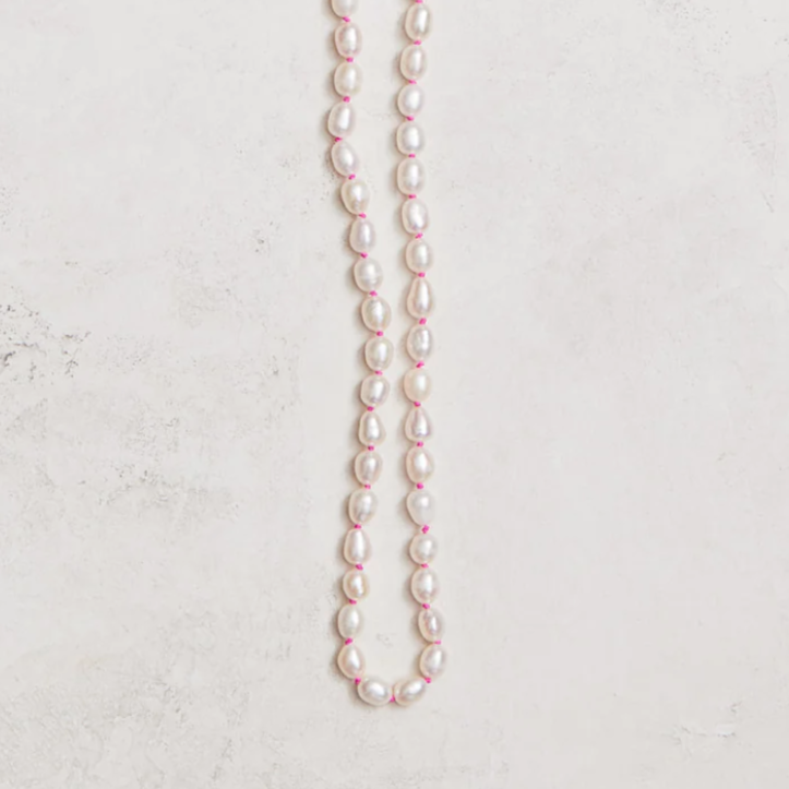 16.5" freshwater pearls hand-knotted on hand-dyed neon silk, gold-filled toggle clasp.  Handmade by Nicole Gerulat.