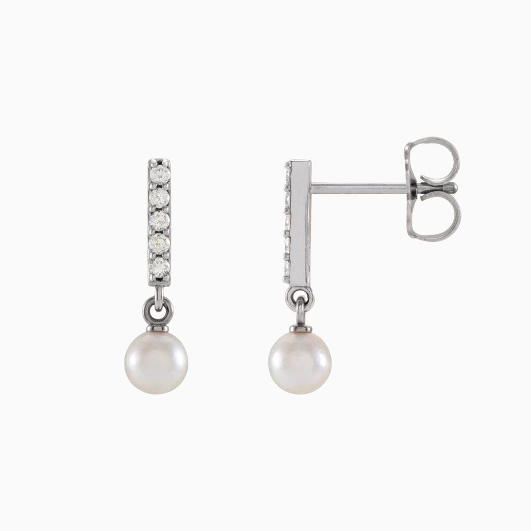 Constructed from 14k gold, these diamond bar earrings boast a cultured akoya pearl drop and .03 CTW of natural diamonds. Choose from yellow, white, and rose gold.