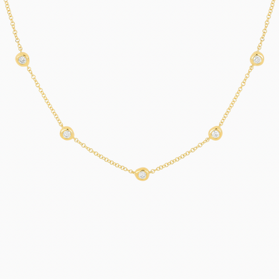 The 5 Diamond Pillow Necklace features five bezel-set diamonds set on a delicate cable chain.  The sculptural bezel setting is a unique design element that gives the gold surrounding these diamonds an organic look, like fluffed pillows.