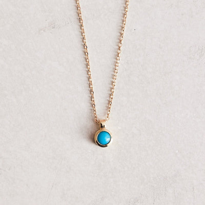 16-18" adjustable 14k gold chain with a bezel-set natural turquoise pendant.