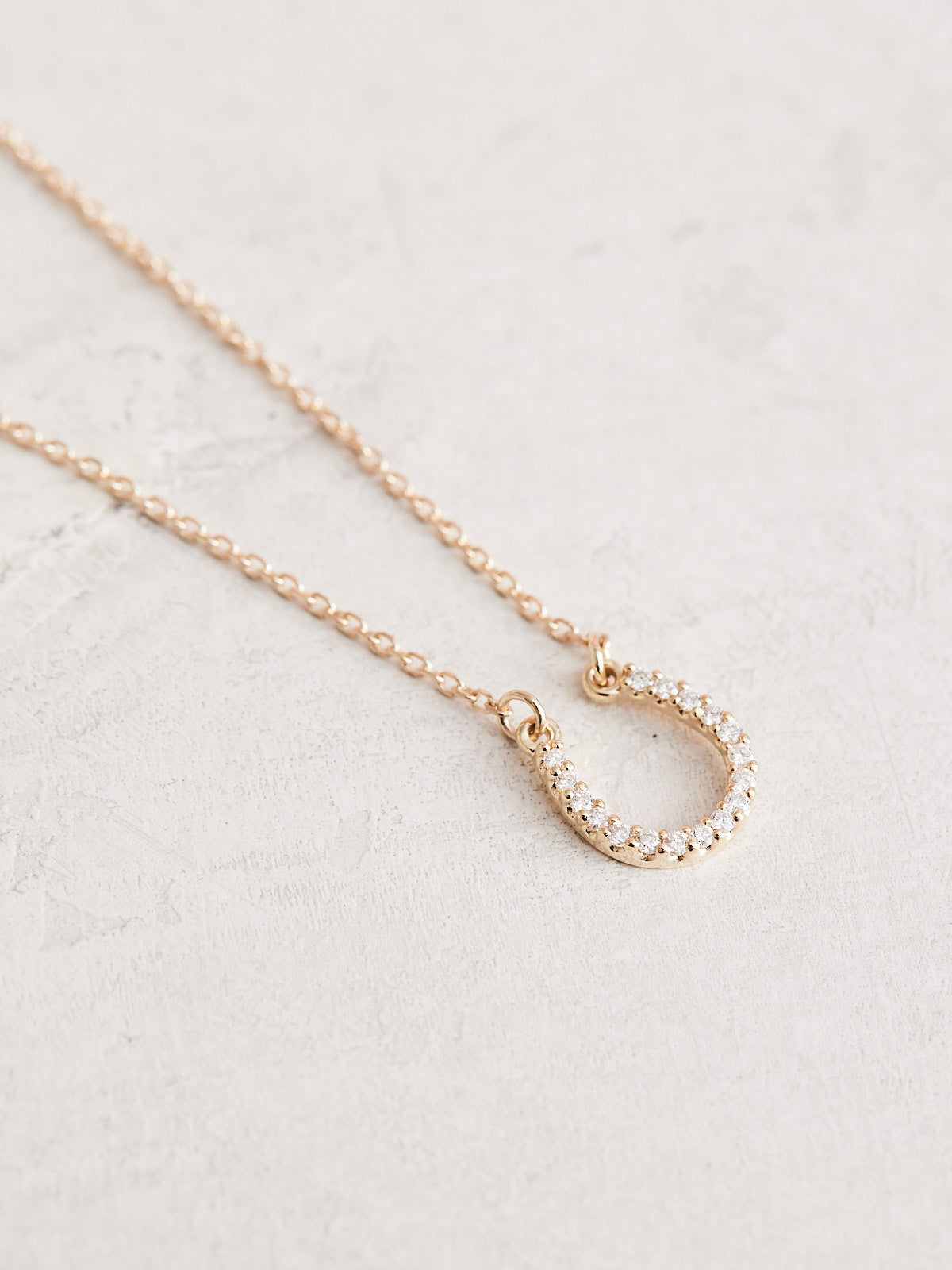  This Cowgirl Up Necklace boasts a 16" 14k gold chain with a 0.07 ctw natural diamond horseshoe.