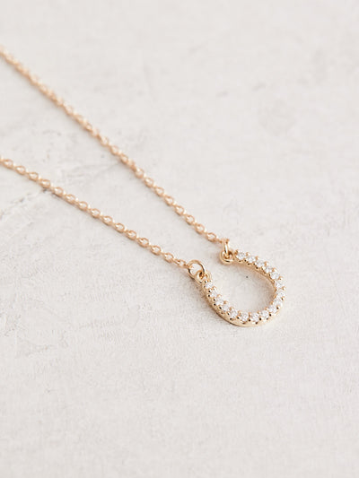  This Cowgirl Up Necklace boasts a 16" 14k gold chain with a 0.07 ctw natural diamond horseshoe.