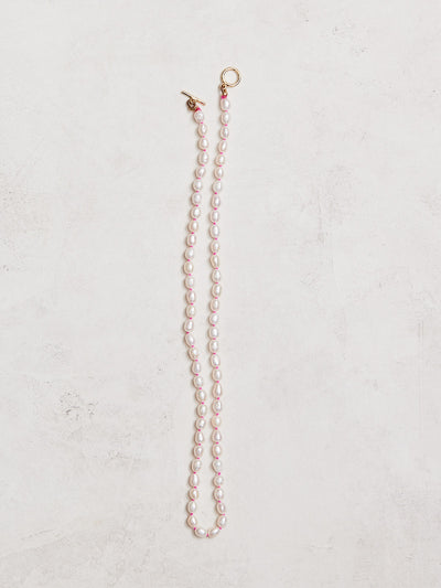 16.5" freshwater pearls hand-knotted on hand-dyed neon silk, gold-filled toggle clasp.  Handmade by Nicole Gerulat.