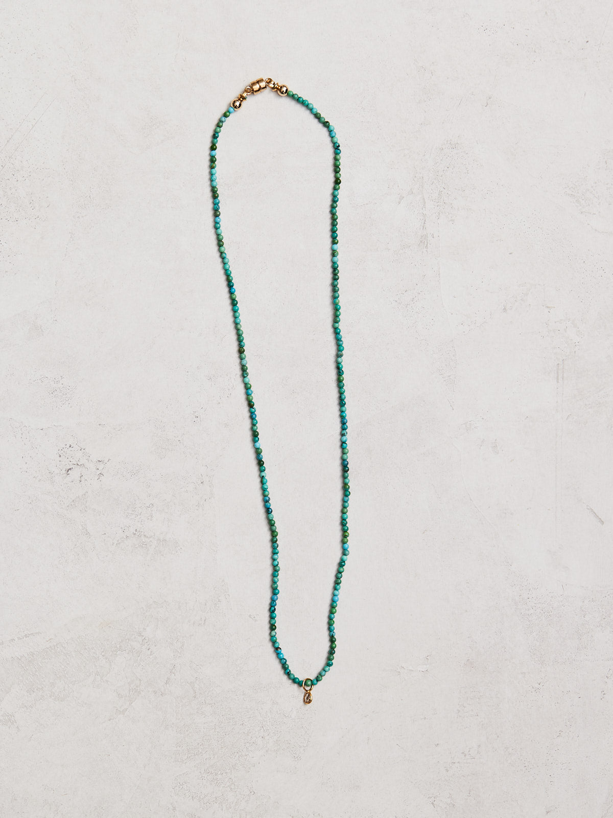 This sophisticated necklace boasts a 16.5" strand of natural turquoise and rose cut diamonds, bezel-set in 14K gold. A secure gold-filled magnetic clasp completes the look, and it has been handmade by with care by Nicole Gerulat.