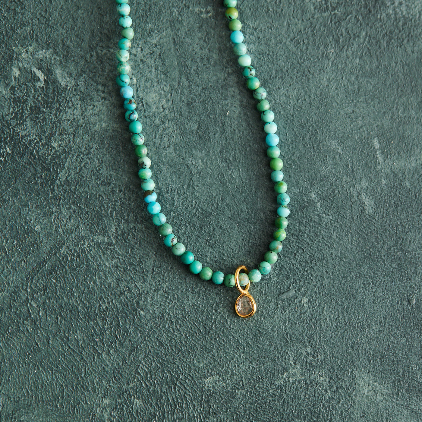 This sophisticated necklace boasts a 16.5" strand of natural turquoise and rose cut diamonds, bezel-set in 14K gold. A secure gold-filled magnetic clasp completes the look, and it has been handmade by with care by Nicole Gerulat.