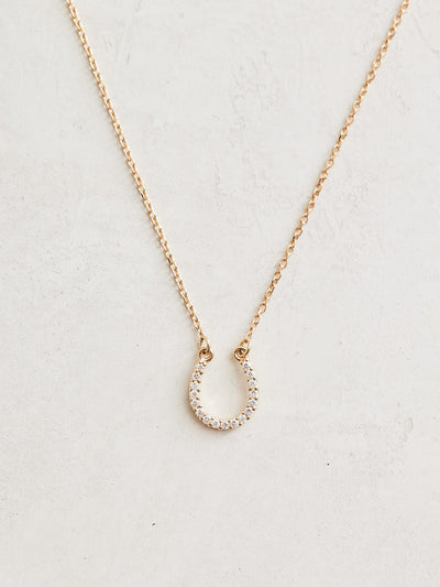  This Cowgirl Up Necklace boasts a 16" 14k gold chain with a 0.07 ctw natural diamond horseshoe.