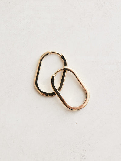 Elongated 14k gold oval huggie hoop earrings