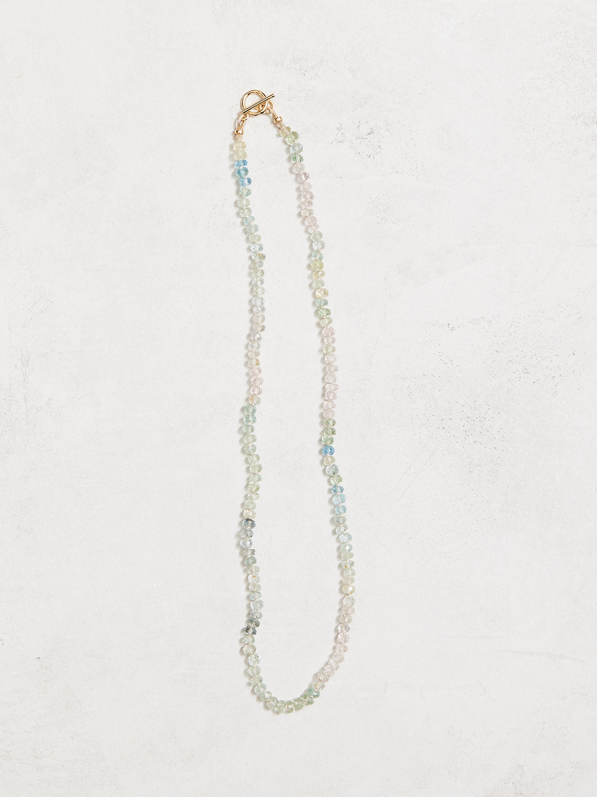 16" faceted aquamarines hand-knotted on ivory silk, gf toggle clasp. Handmade by Nicole Gerulat.