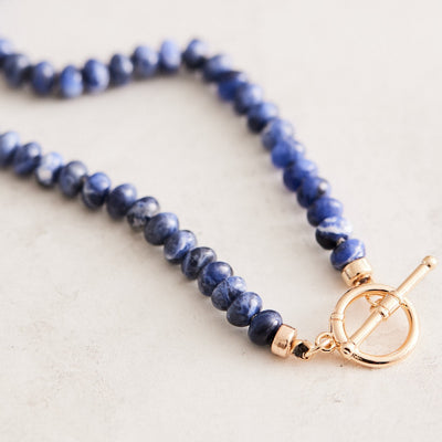 17" natural blue lapis necklace hand-knotted on gray silk with gold-filled findings and toggle clasp. Handmade by Nicole Gerulat.