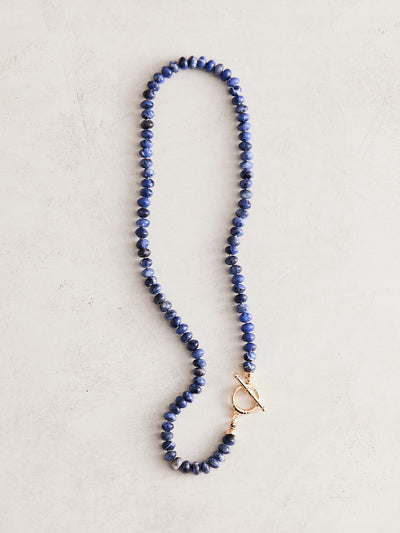 17" natural blue lapis necklace hand-knotted on gray silk with gold-filled findings and toggle clasp. Handmade by Nicole Gerulat.