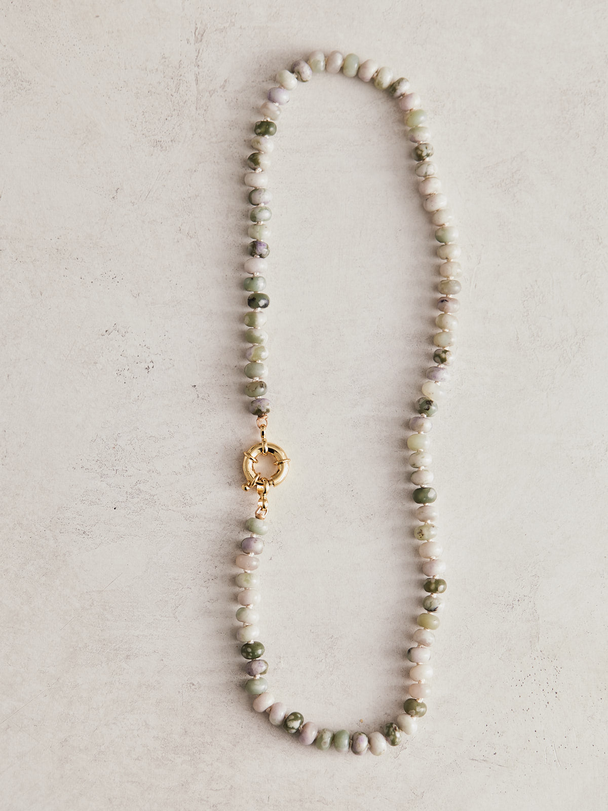 16" 6mm natural lavendar jade, hand-knotted on ivory silk with gold-filled findings and sailor clasp. Handmade by Nicole Gerulat.