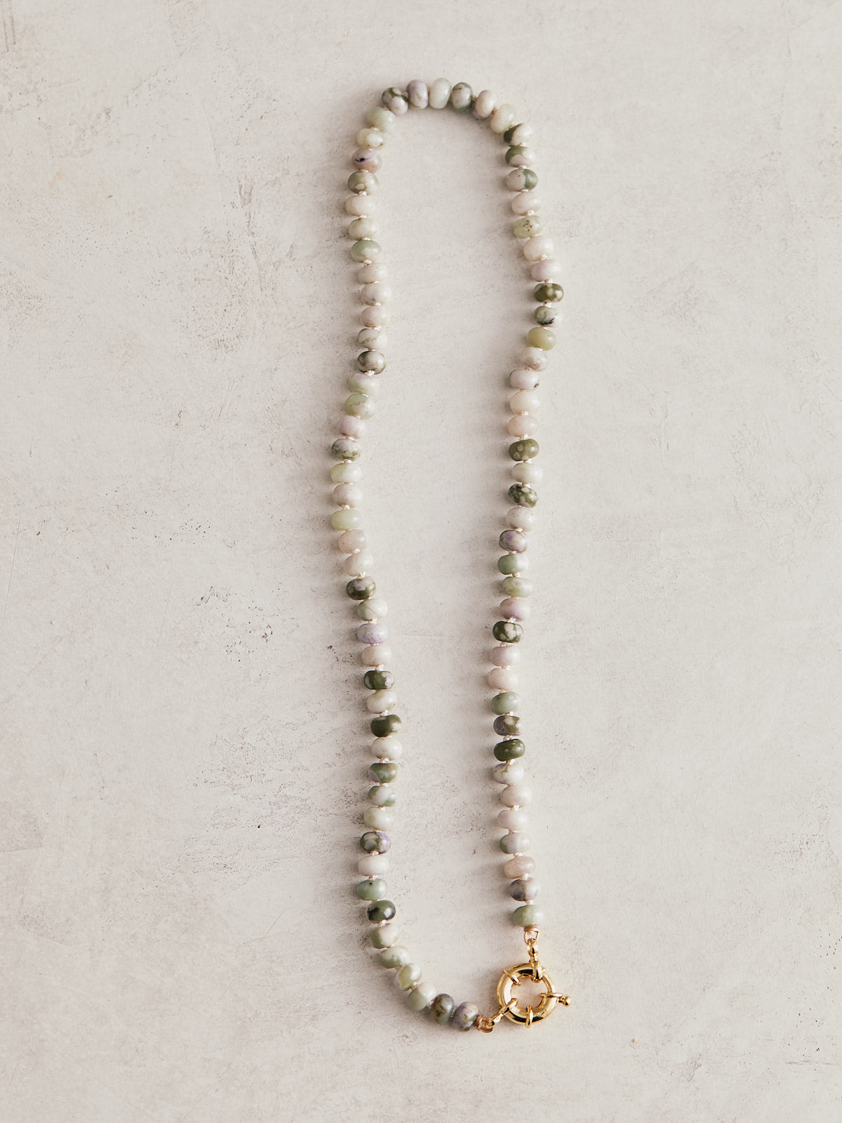 16" 6mm natural lavendar jade, hand-knotted on ivory silk with gold-filled findings and sailor clasp. Handmade by Nicole Gerulat.