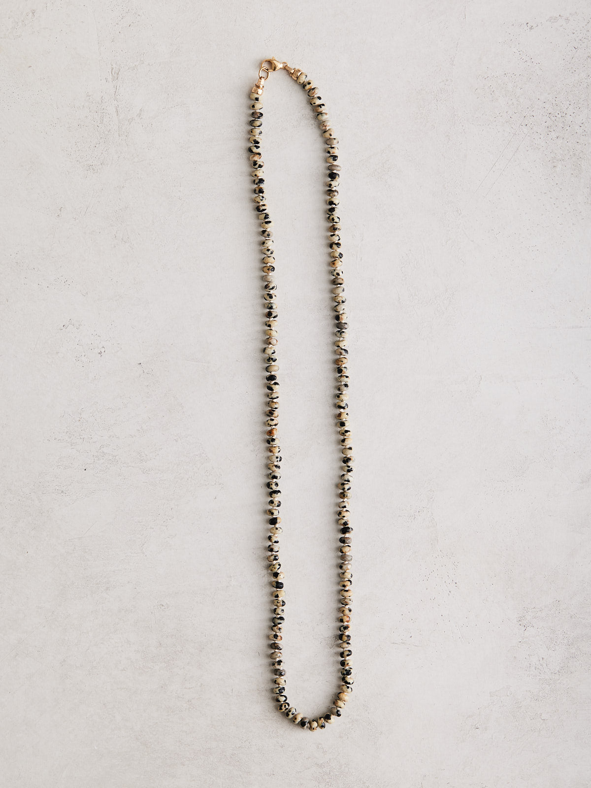 This 18.5" necklace is crafted with natural dalmation jasper and hand-knotted on silk with gold-filled findings plus a lobster clasp. Handmade with care by Nicole Gerulat.