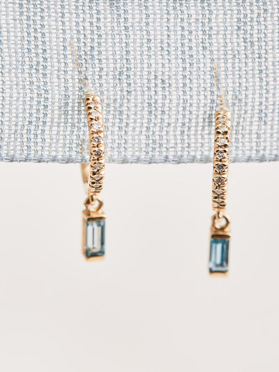 14K Yellow Gold Hoop Earrings with .08 CTW Natural Diamond & Natural London Blue Topaz drops. Sold as a pair.