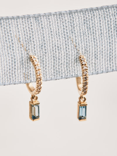 14K Yellow Gold Hoop Earrings with .08 CTW Natural Diamond & Natural London Blue Topaz drops. Sold as a pair.