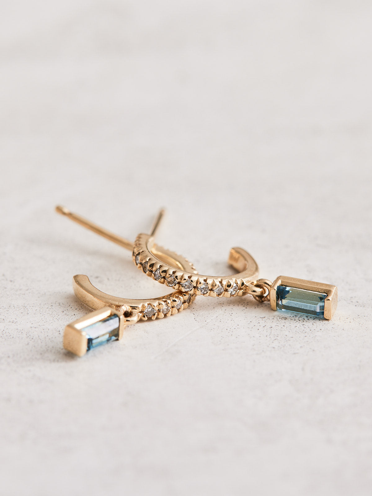 14K Yellow Gold Hoop Earrings with .08 CTW Natural Diamond & Natural London Blue Topaz drops. Sold as a pair.