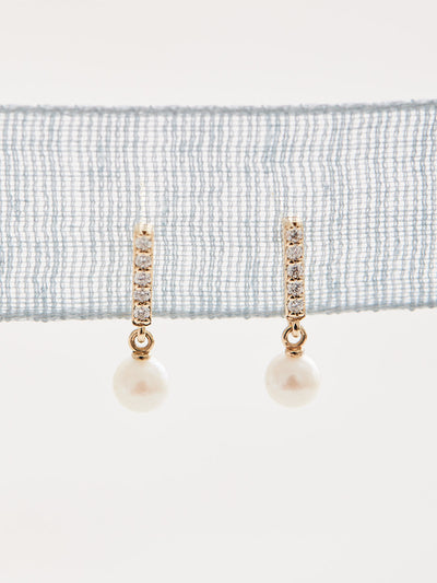 Constructed from 14k gold, these diamond bar earrings boast a cultured akoya pearl drop and .03 CTW of natural diamonds. Choose from yellow, white, and rose gold.