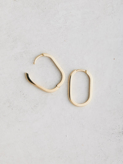 Elongated 14k gold oval huggie hoop earrings