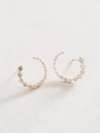 These front-back diamond earrings have 7/8 ctw natural diamonds set in 14k gold. The graduated end tucks behind the lobe for a beautiful illusion of a completed circle that stays facing front. 15mm. Available in white, yellow and rose gold.