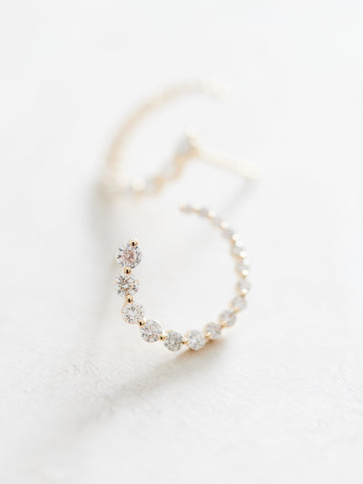 These front-back diamond earrings have 7/8 ctw natural diamonds set in 14k gold. The graduated end tucks behind the lobe for a beautiful illusion of a completed circle that stays facing front. 15mm. Available in white, yellow and rose gold.