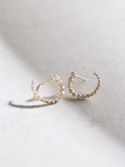 These front-back diamond earrings have 7/8 ctw natural diamonds set in 14k gold. The graduated end tucks behind the lobe for a beautiful illusion of a completed circle that stays facing front. 15mm. Available in white, yellow and rose gold.