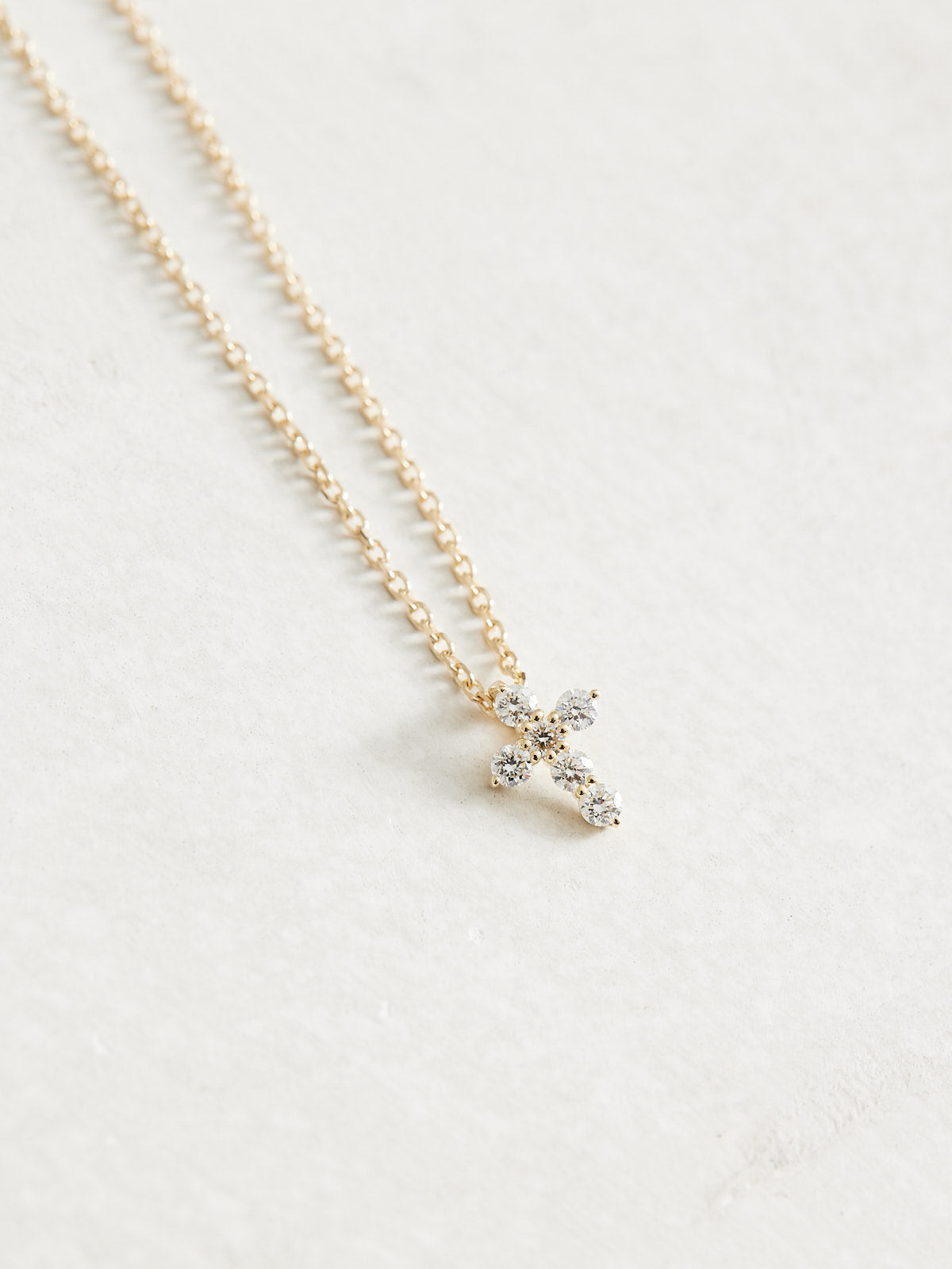 This adjustable 16-18" 14k Gold & Natural Diamonds Cross Necklace features 1/6 ct of Natural Diamonds in an 8.7 x 6.3mm size. It is available in yellow, white, and rose gold.